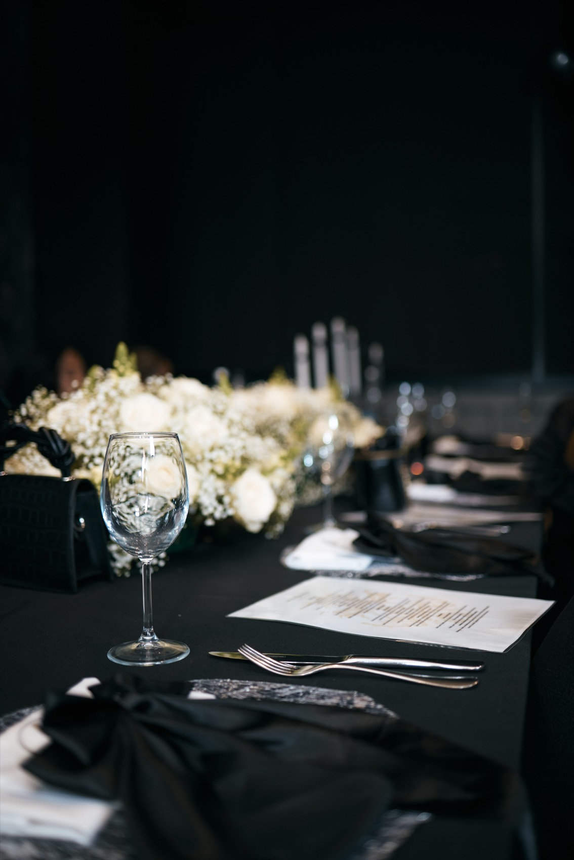 Styled table setting at a black and white birthday dinner