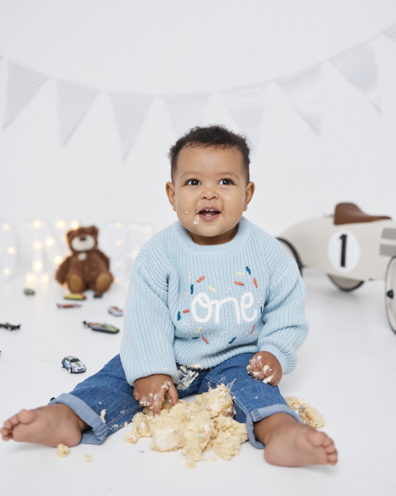 Toddler laughing on a playful studio set