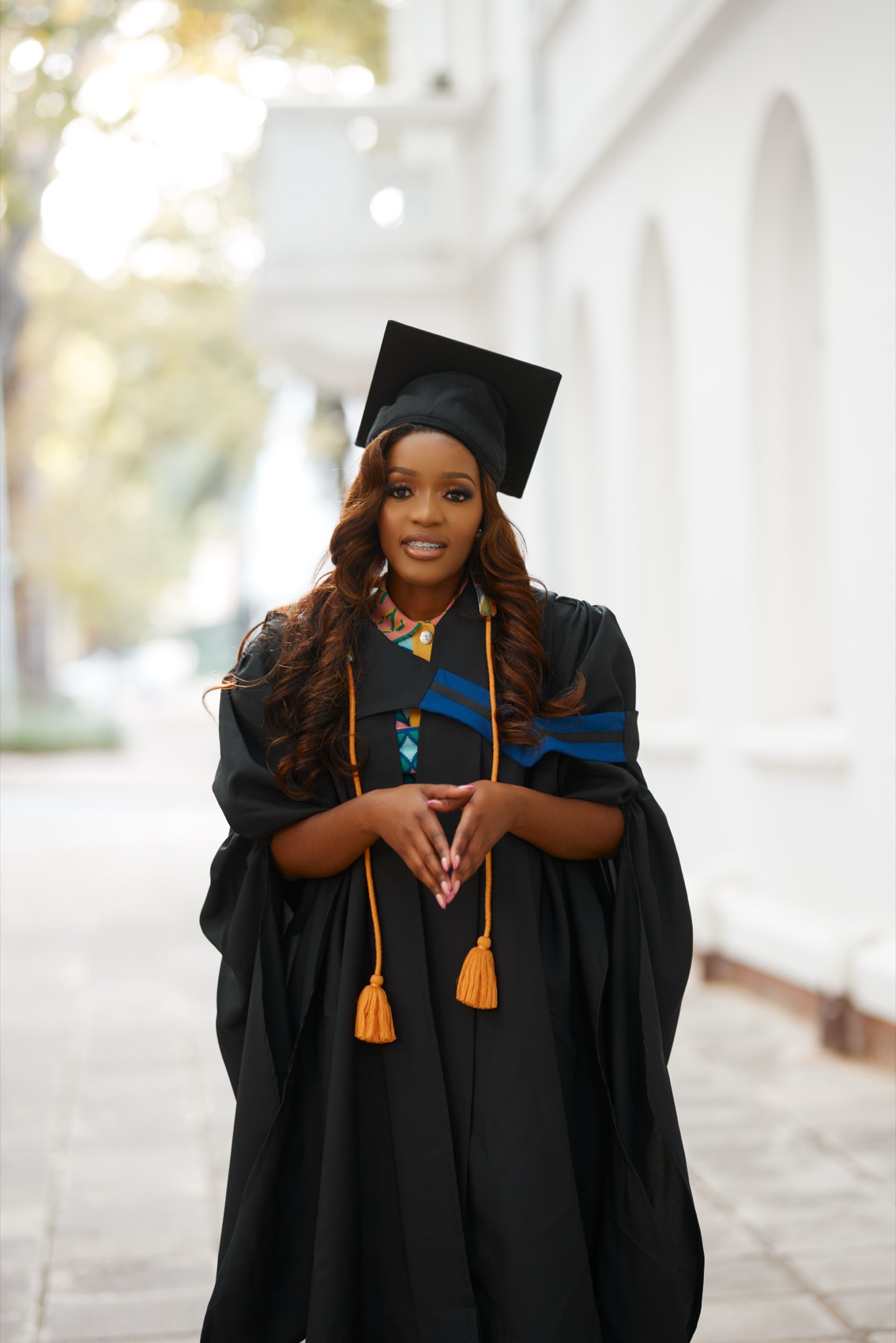 Graduate photographed on campus after the ceremony