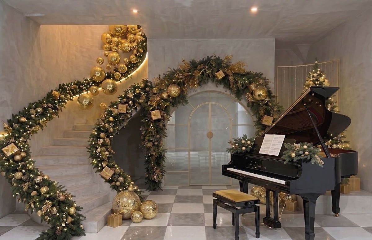 The Noel Set — gold garland staircase and grand piano at Jepson Myles Studio